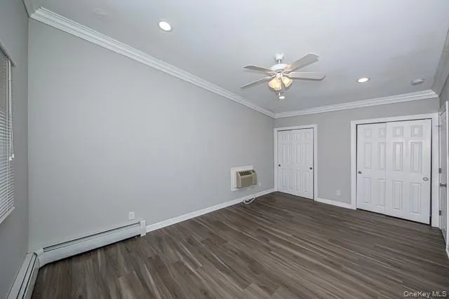wooden floor in an empty room with a ceiling fan