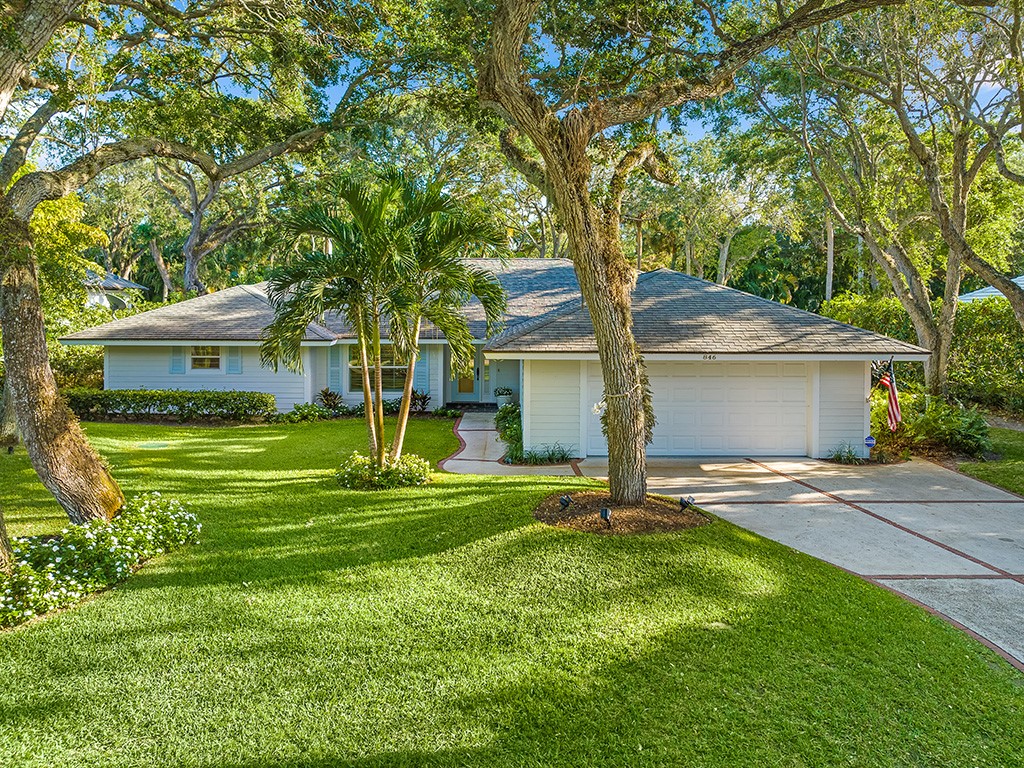 a view of a house with a yard and tree s
