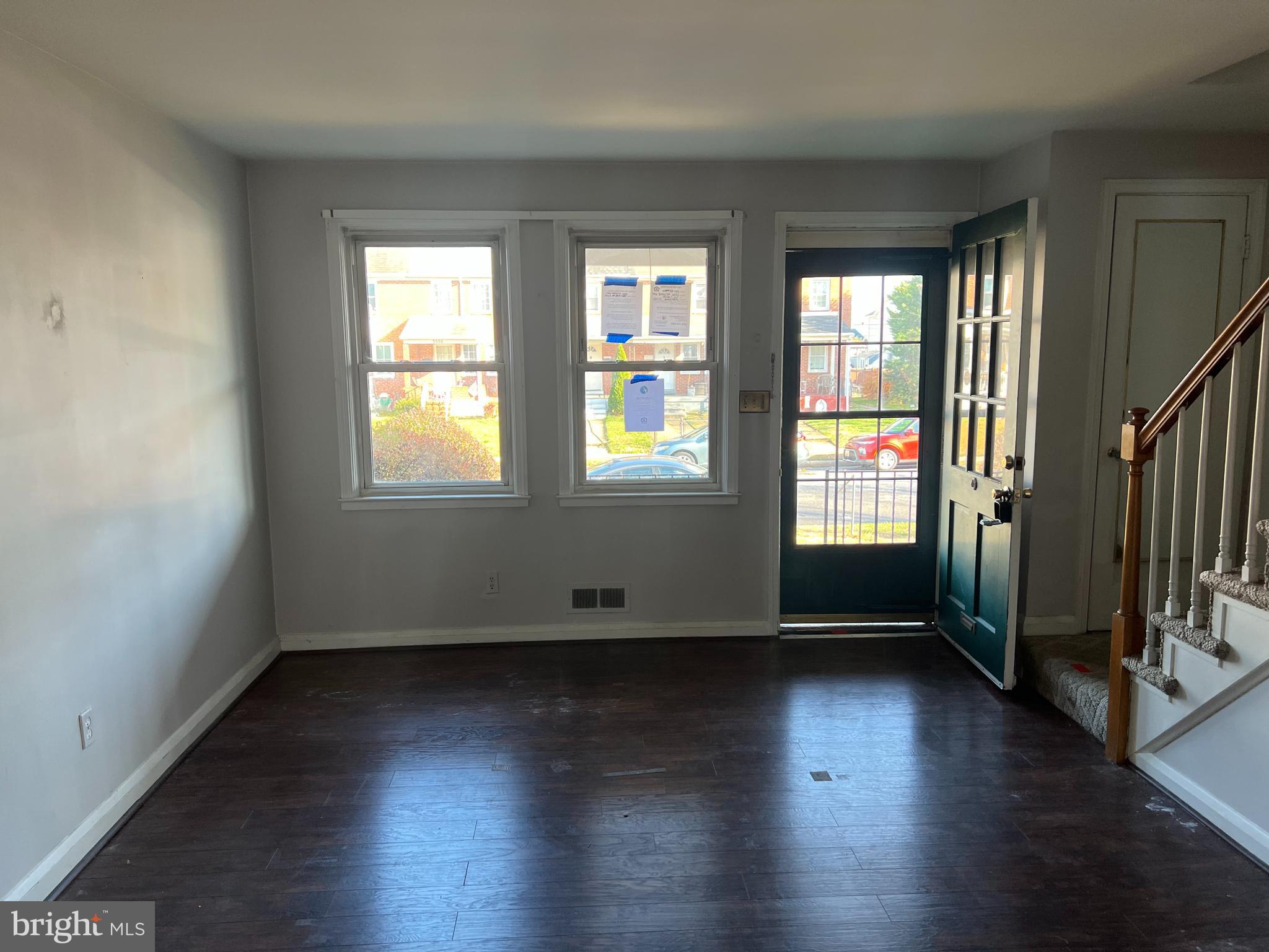 3536 McShane Way Baltimore, MD 21222 - Photo 2 of 11 an empty room with wooden floor and windows