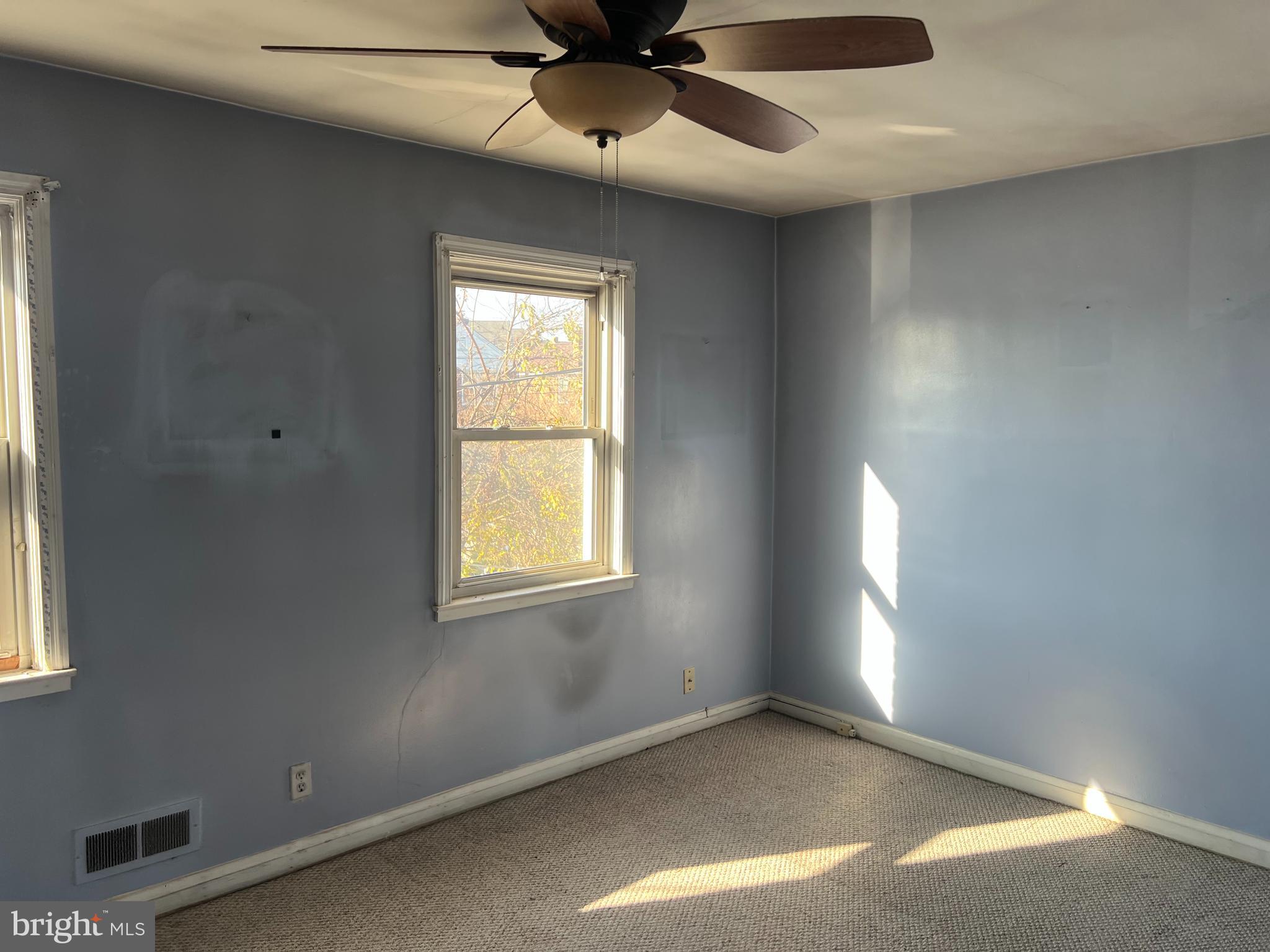 3536 McShane Way Baltimore, MD 21222 - Photo 7 of 11 an empty room with windows and fan