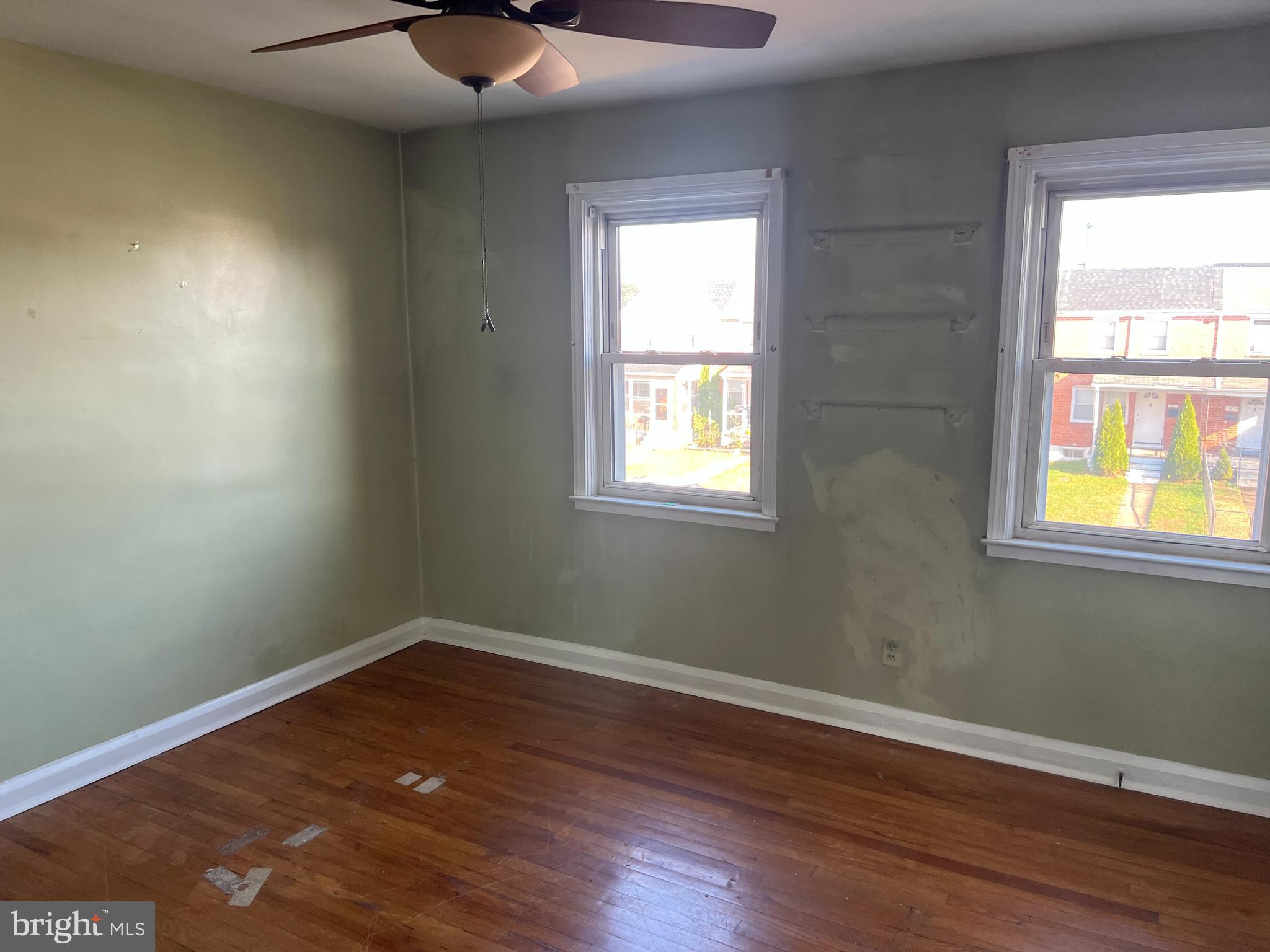 3536 McShane Way Baltimore, MD 21222 - Photo 9 of 11 a view of an empty room with wooden floor and a window