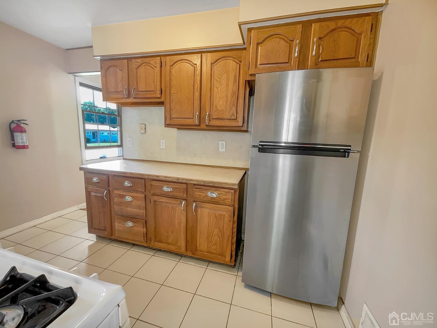 73 Princeton Road Old Bridge, NJ 08859 - Photo 8 of 20 a kitchen with stainless steel appliances a refrigerator and cabinets