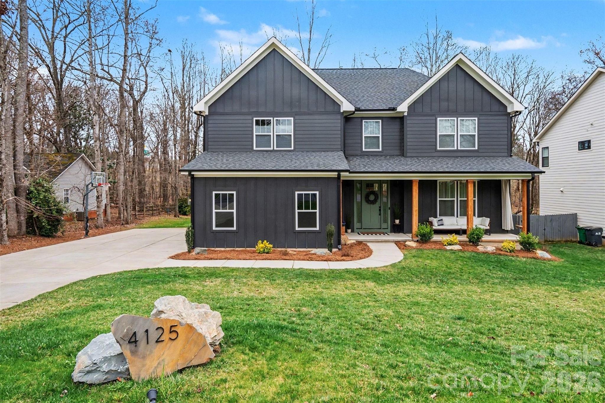 a front view of a house with a yard and porch
