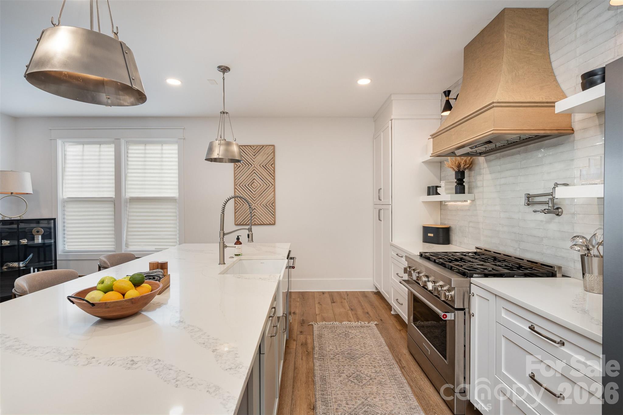 4125 Spring Street Charlotte, NC 28270 - Photo 11 of 37 a kitchen with a sink a stove and a wooden floor