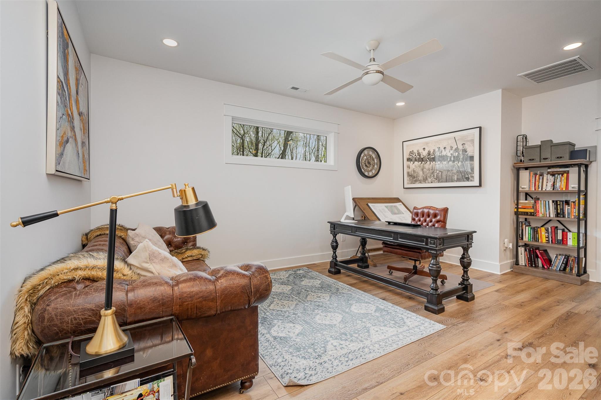 4125 Spring Street Charlotte, NC 28270 - Photo 26 of 37 a living room with furniture and a bookshelf