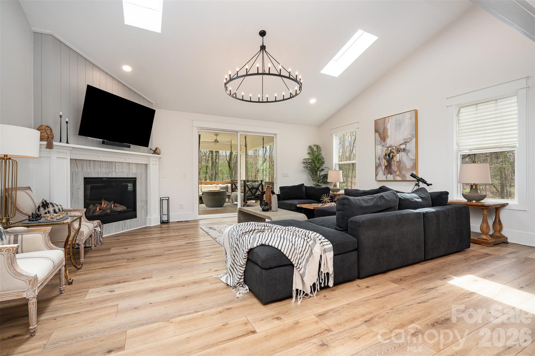 4125 Spring Street Charlotte, NC 28270 - Photo 4 of 37 a living room with furniture a fireplace and a flat screen tv