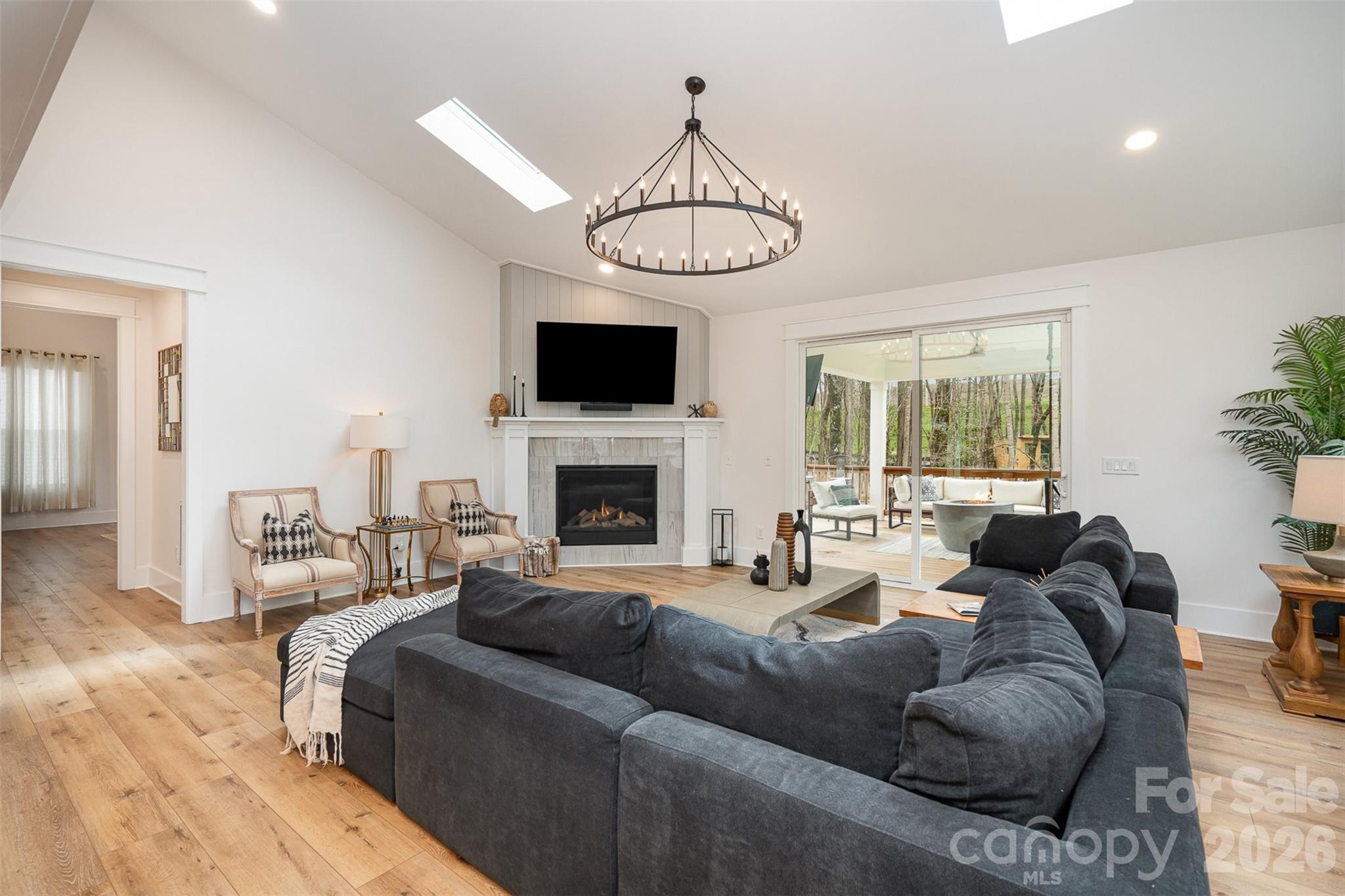4125 Spring Street Charlotte, NC 28270 - Photo 5 of 37 a living room with furniture a fireplace and a flat screen tv