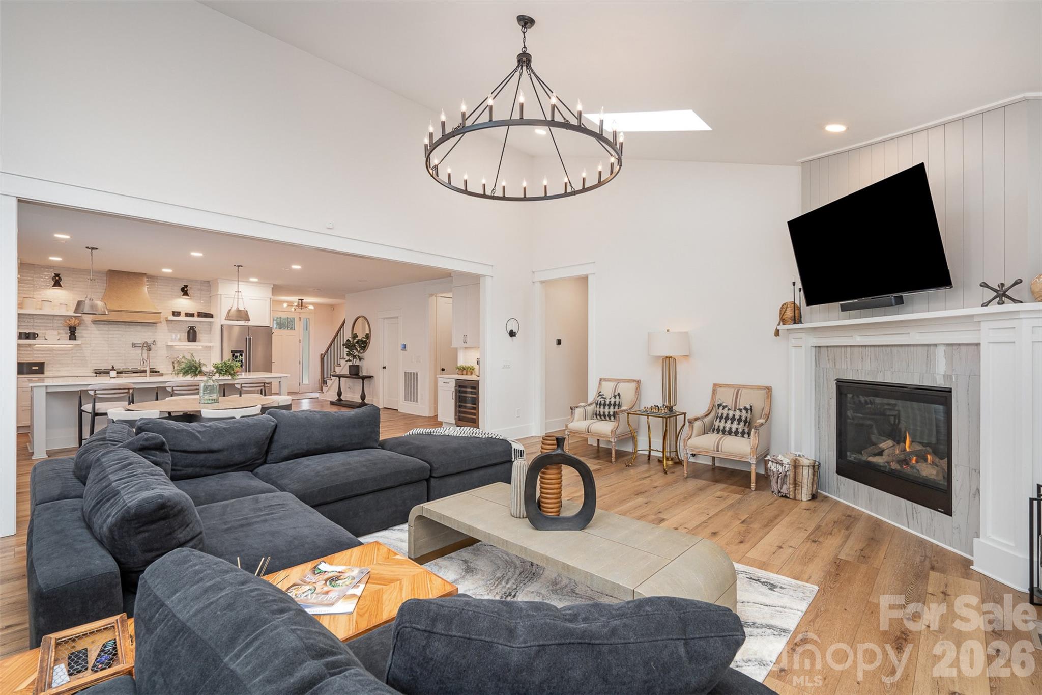 4125 Spring Street Charlotte, NC 28270 - Photo 6 of 37 a living room with furniture a fireplace and a flat screen tv