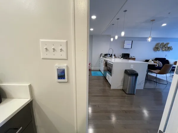 a large white kitchen with a sink a refrigerator and a stove