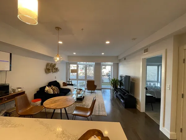 a living room with furniture a couch and wooden floor