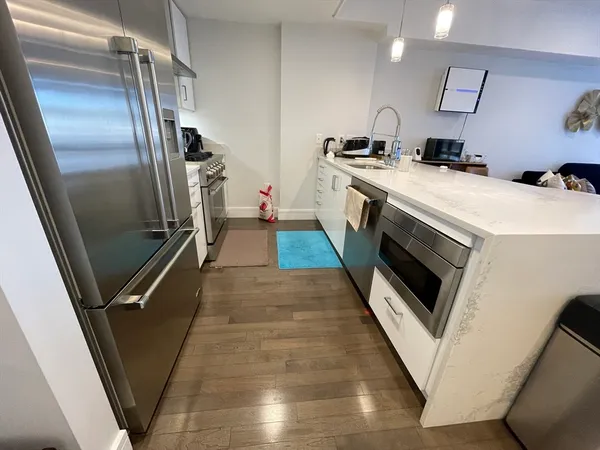 a kitchen with stainless steel appliances a stove a microwave and a refrigerator