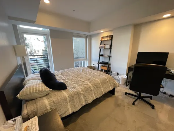 a bedroom with a bed and a chair