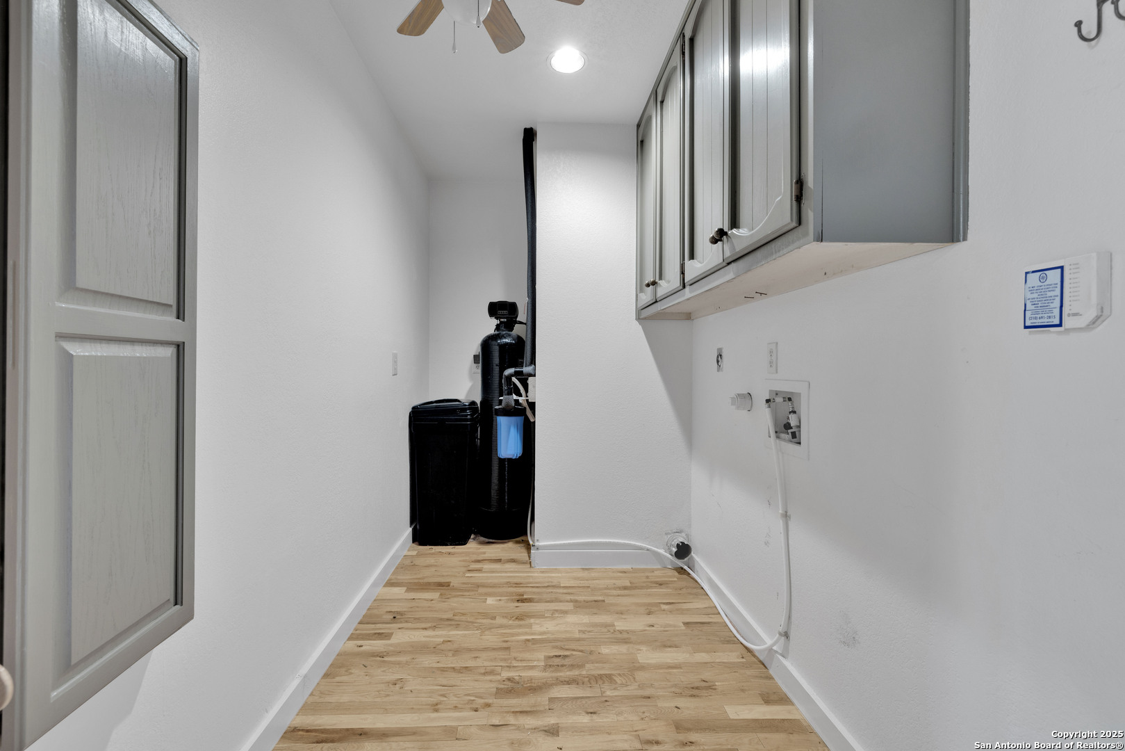 11361 Moonsail Helotes, TX 78023 - Photo 16 of 27 a view of a hallway with wooden floor and staircase