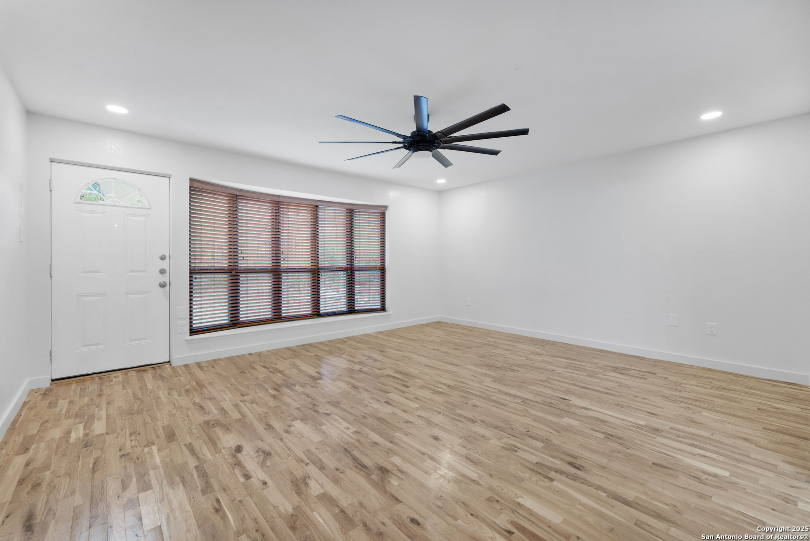 11361 Moonsail Helotes, TX 78023 - Photo 20 of 27 a view of an empty room with a window and wooden floor
