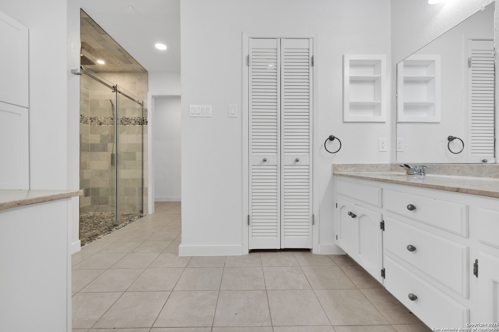 11361 Moonsail Helotes, TX 78023 - Photo 22 of 27 a bathroom with a granite countertop sink a mirror and a shower