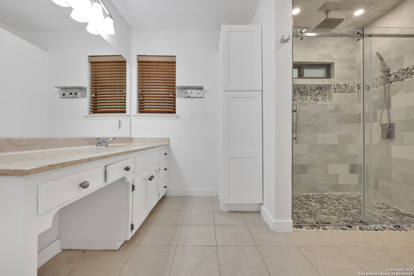 11361 Moonsail Helotes, TX 78023 - Photo 24 of 27 a bathroom with a granite countertop sink a large mirror and shower