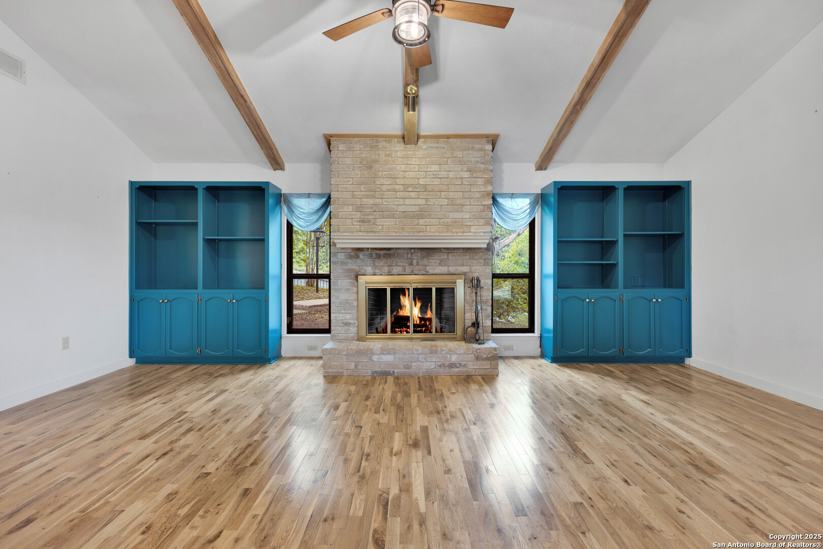 11361 Moonsail Helotes, TX 78023 - Photo 7 of 27 a view of an empty room with a fireplace and a window
