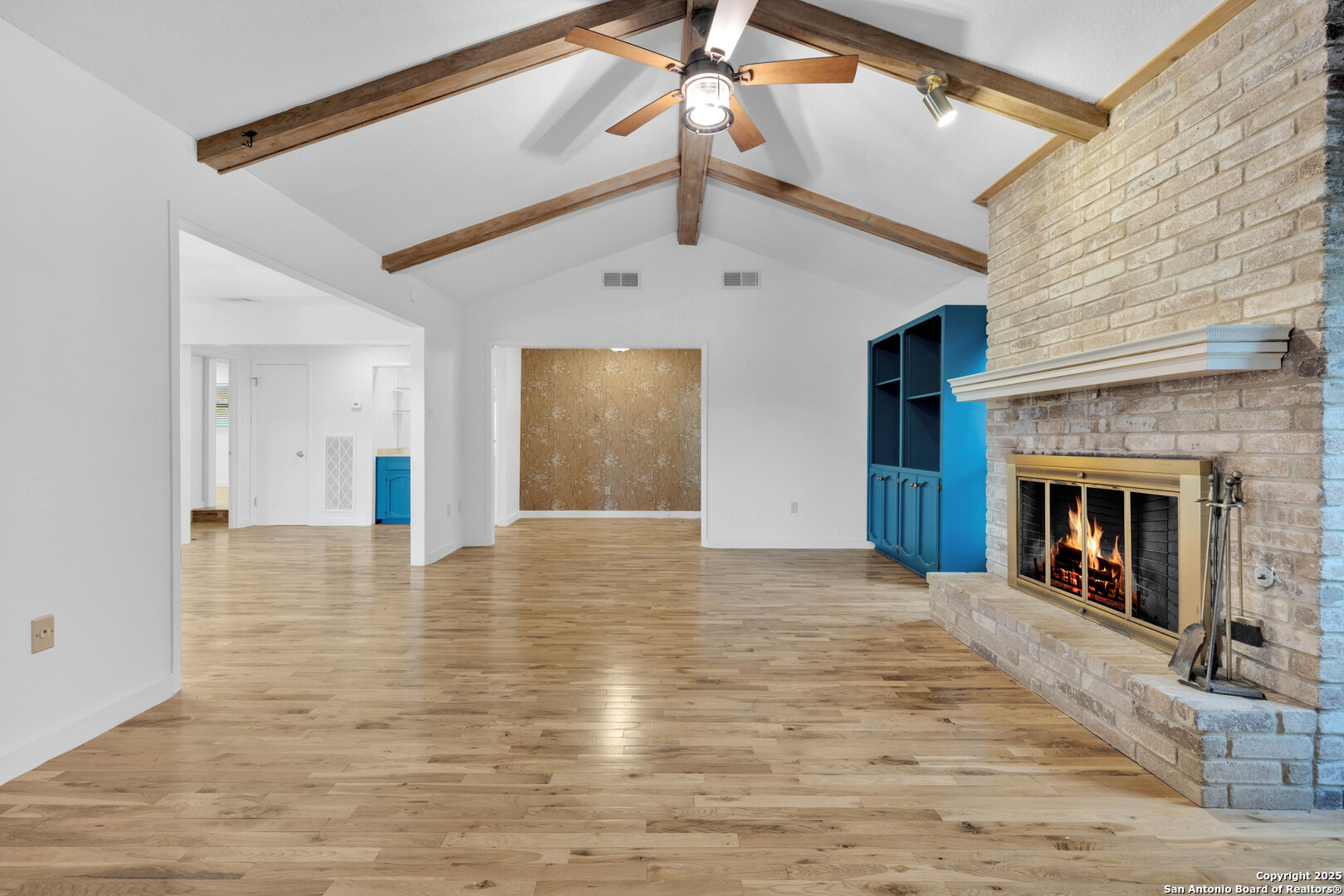 11361 Moonsail Helotes, TX 78023 - Photo 8 of 27 a view of an empty room with wooden floor fireplace and a window