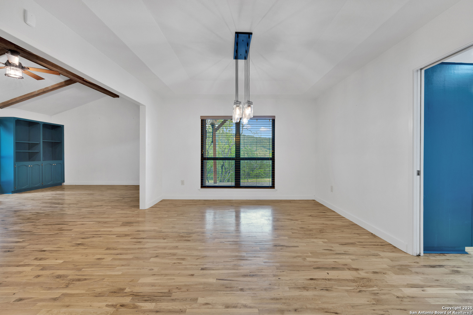 11361 Moonsail Helotes, TX 78023 - Photo 10 of 27 a view of an empty room with window and wooden floor