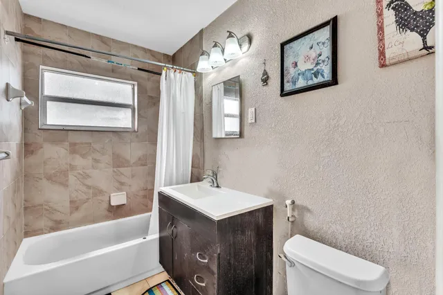 a bathroom with a sink a toilet and bathtub