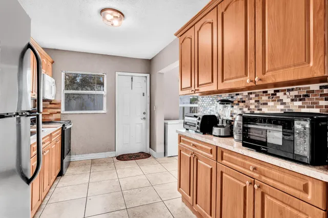 a kitchen with stainless steel appliances a stove a sink and a microwave