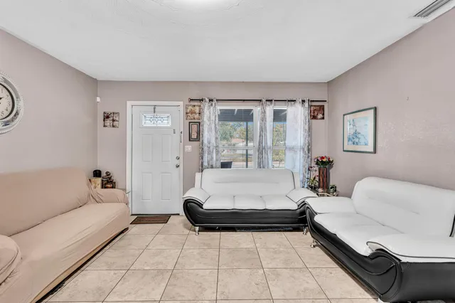 a spacious bedroom with a bed and glass window