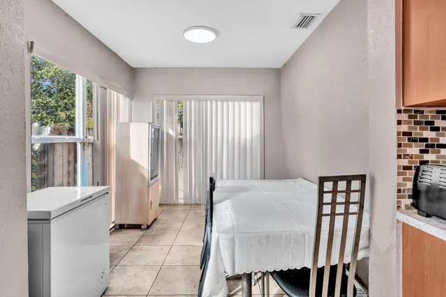 a view of kitchen with furniture and large window