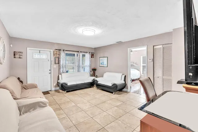 a bedroom with furniture and a large window