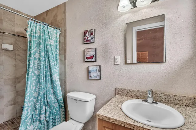 a bathroom with a toilet a sink and a mirror