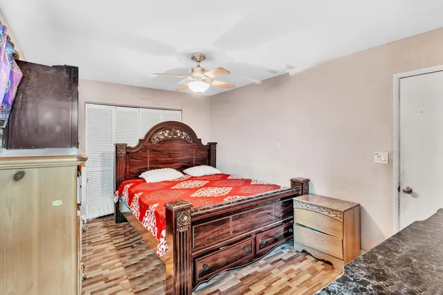 a bedroom with a bed and a chandelier