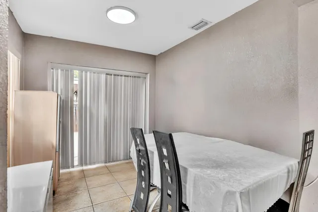 a view of a dining room with furniture and window