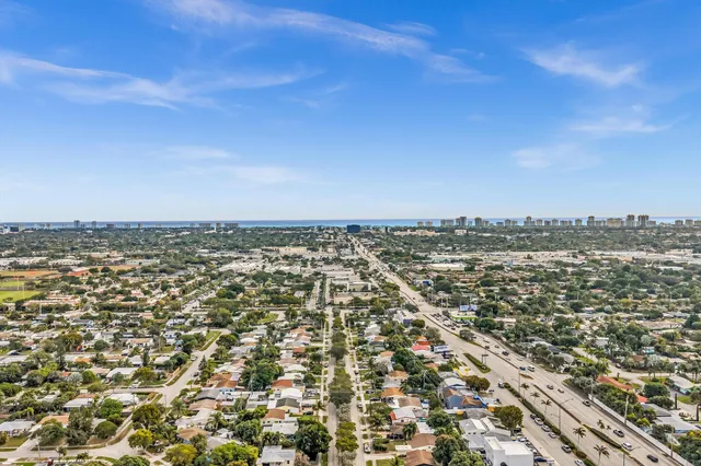 an aerial view of residential houses with yard