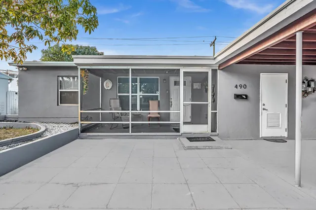front view of a house with barbeque and stairs