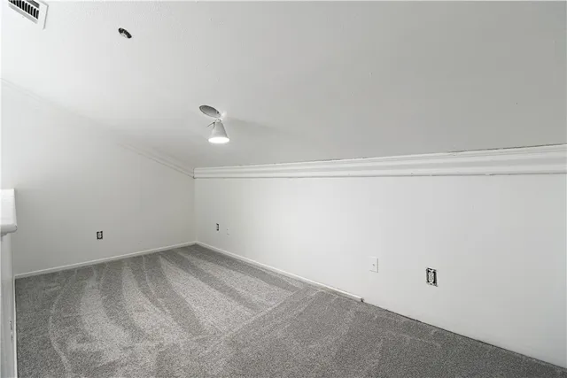 an empty room with a window and a ceiling fan