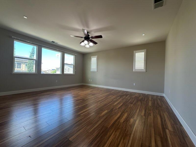 1749 Ettle Street Manteca, CA 95337 - Photo 7 of 12 a view of an empty room with wooden floor and a window