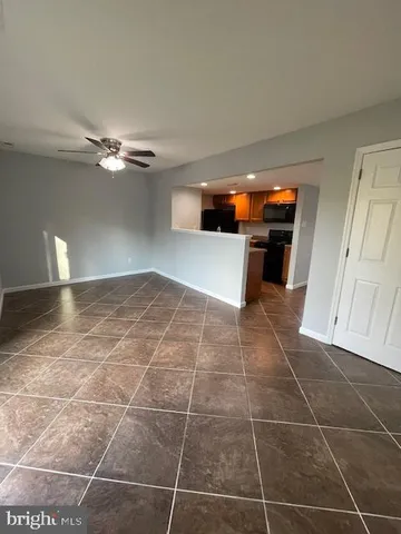 a view of kitchen with furniture and electronic appliances