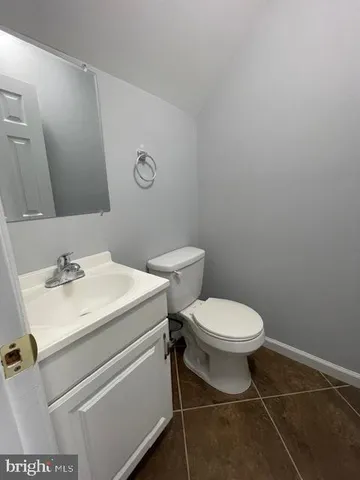 a bathroom with a sink toilet and a mirror