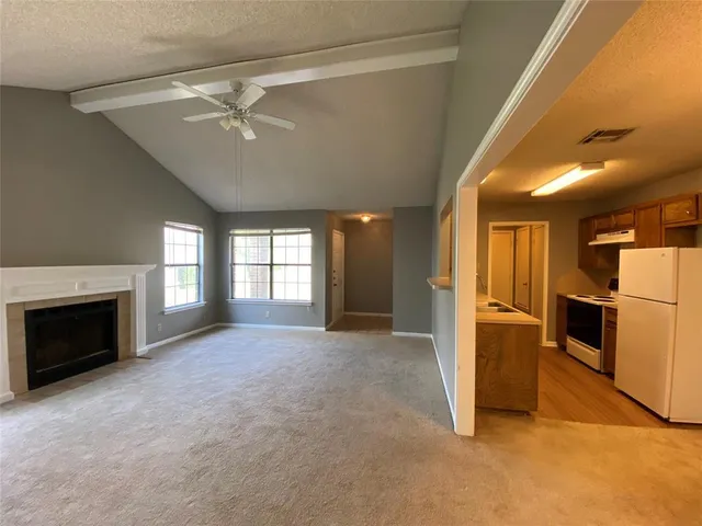 a view of a kitchen with a sink and a fireplace
