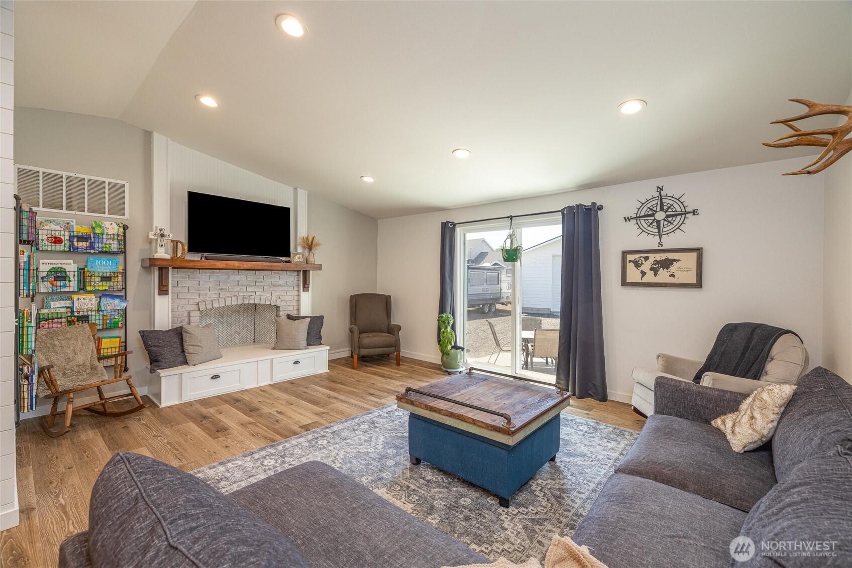 8679 Depot Road Lynden, WA 98264 - Photo 11 of 40 a living room with furniture a fireplace and a flat screen tv