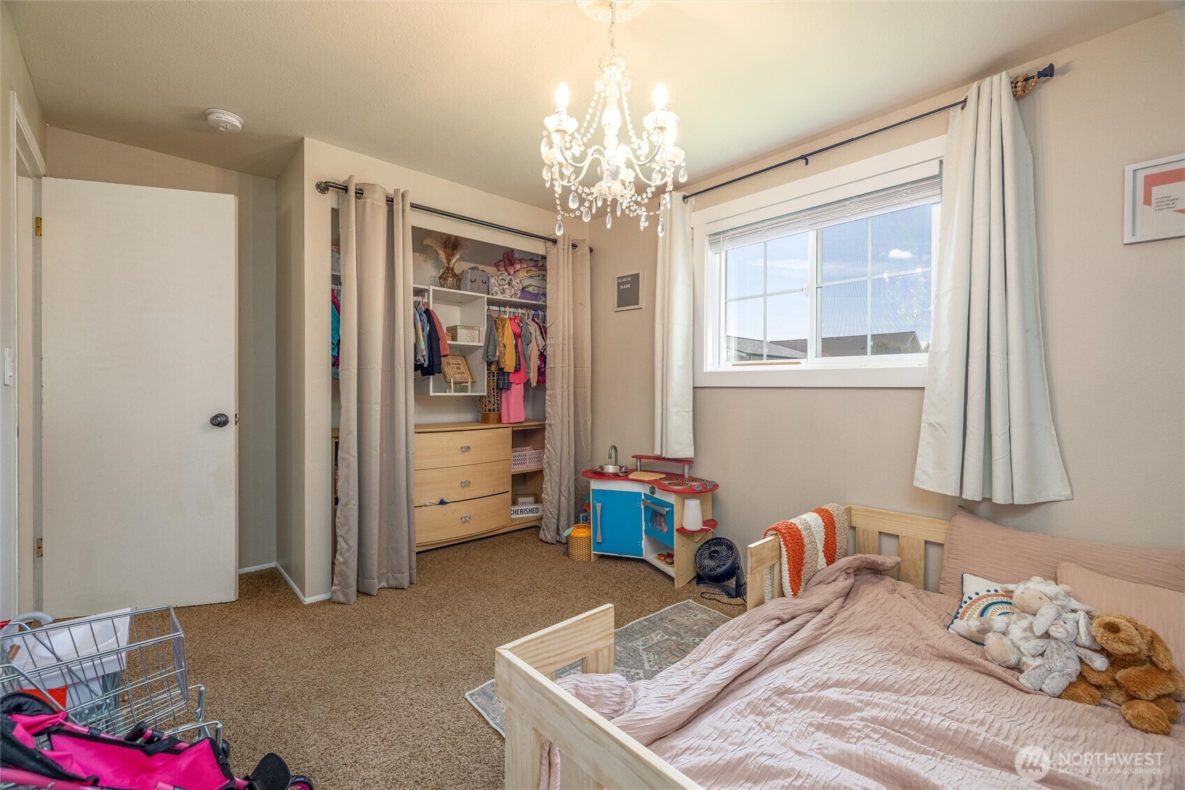 8679 Depot Road Lynden, WA 98264 - Photo 20 of 40 a bedroom with bed and a chandelier