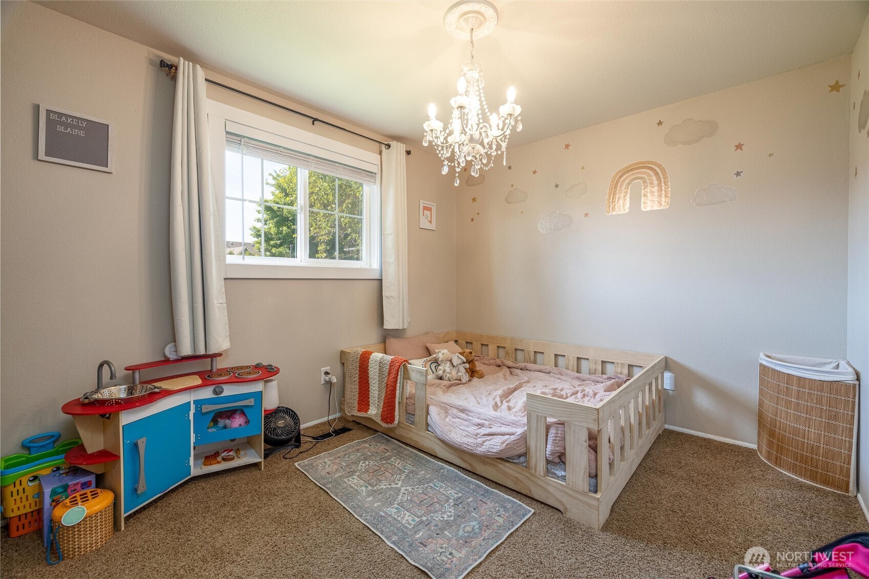 8679 Depot Road Lynden, WA 98264 - Photo 21 of 40 a bedroom with a bed and a chandelier
