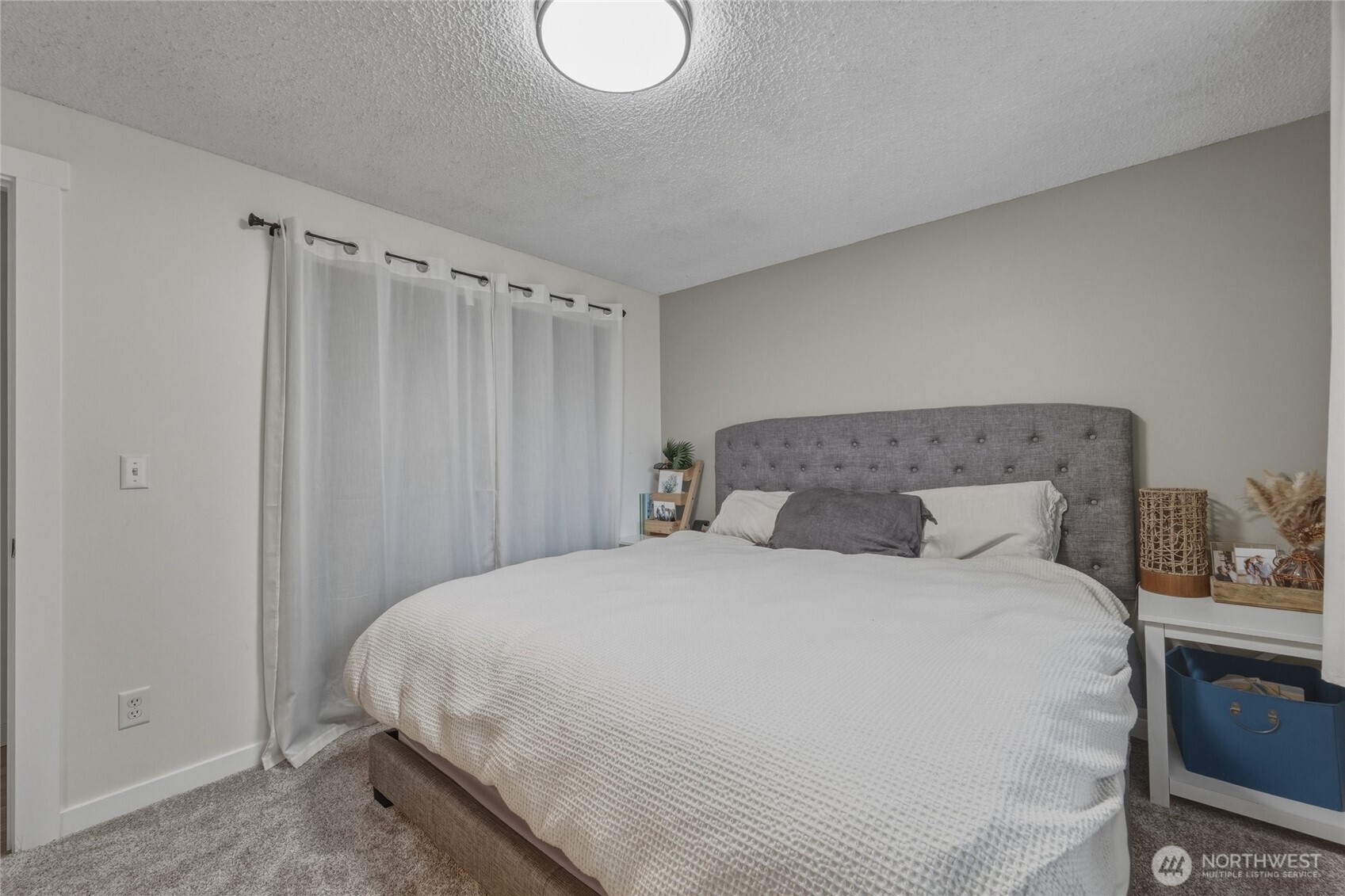 8679 Depot Road Lynden, WA 98264 - Photo 25 of 40 a large bed sitting in a bedroom next to a window