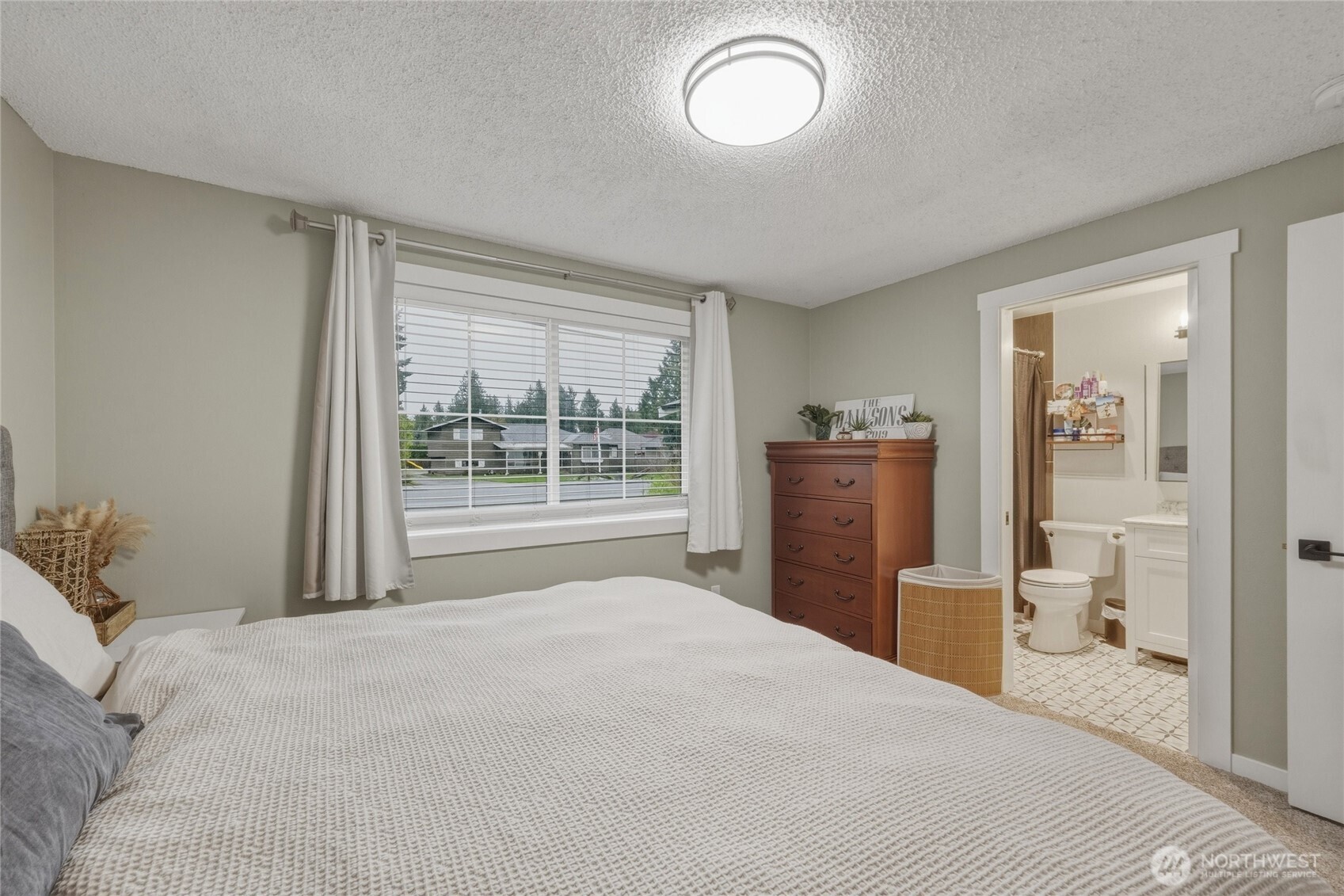 8679 Depot Road Lynden, WA 98264 - Photo 34 of 40 a bedroom with a bed and wooden floor