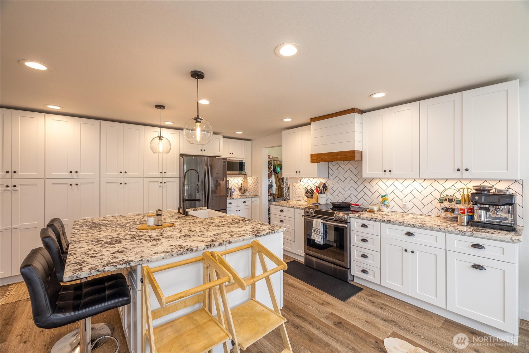 8679 Depot Road Lynden, WA 98264 - Photo 8 of 40 a kitchen with granite countertop white cabinets and stainless steel appliances