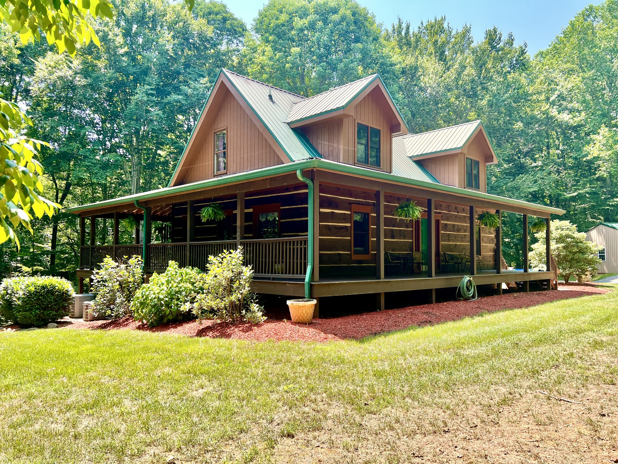 a view of a house with a yard and sitting area
