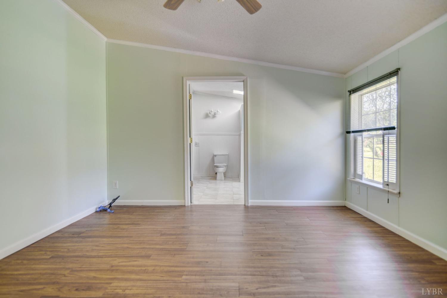 349 Theta Mill Road Gladys, VA 24554 - Photo 14 of 48 an empty room with wooden floor and windows