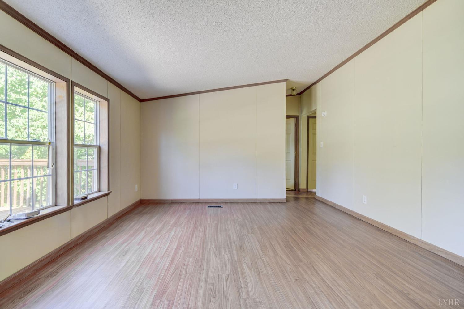 349 Theta Mill Road Gladys, VA 24554 - Photo 20 of 48 an empty room with wooden floor and windows