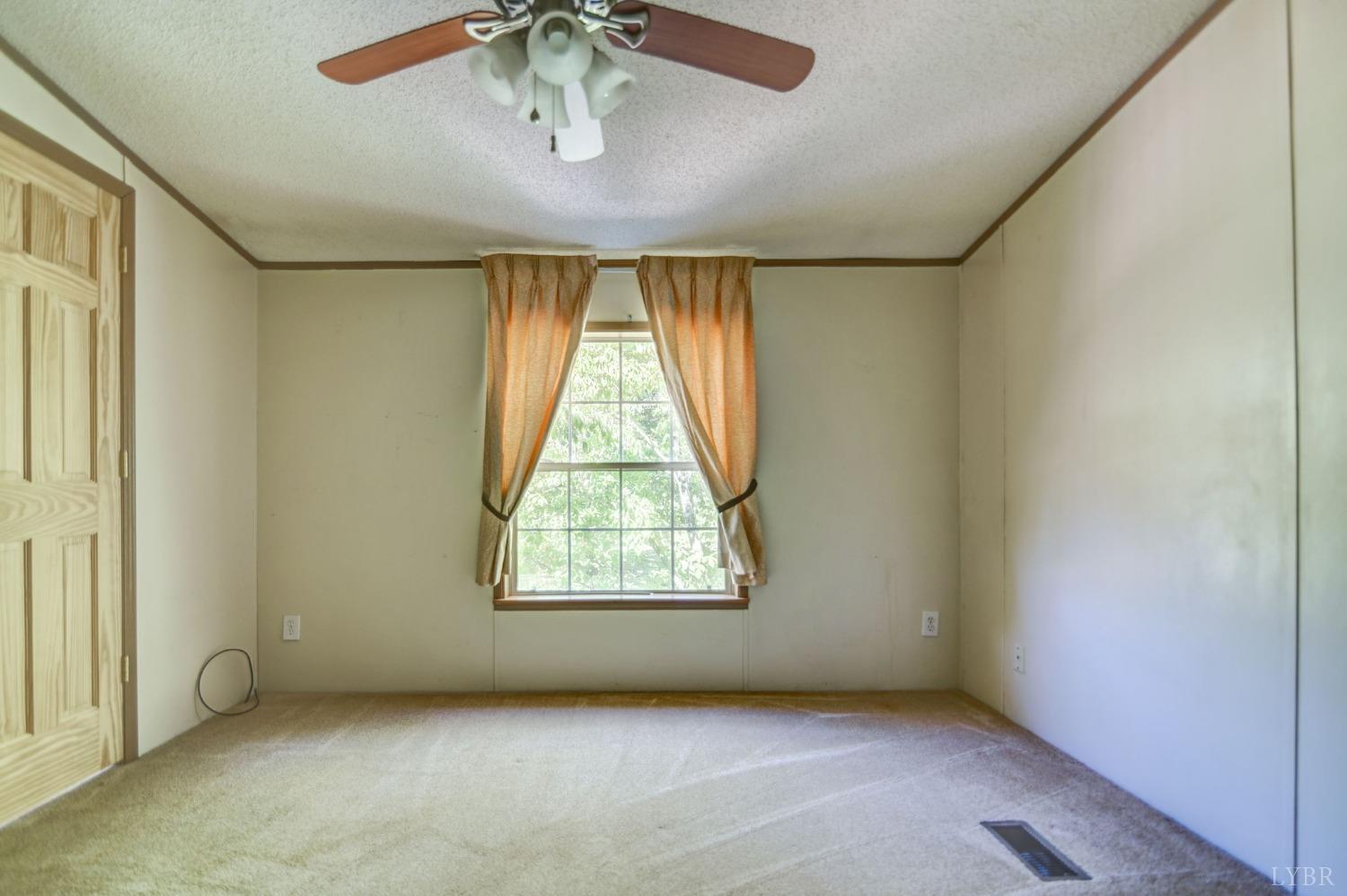 349 Theta Mill Road Gladys, VA 24554 - Photo 22 of 48 an empty room with windows and fan