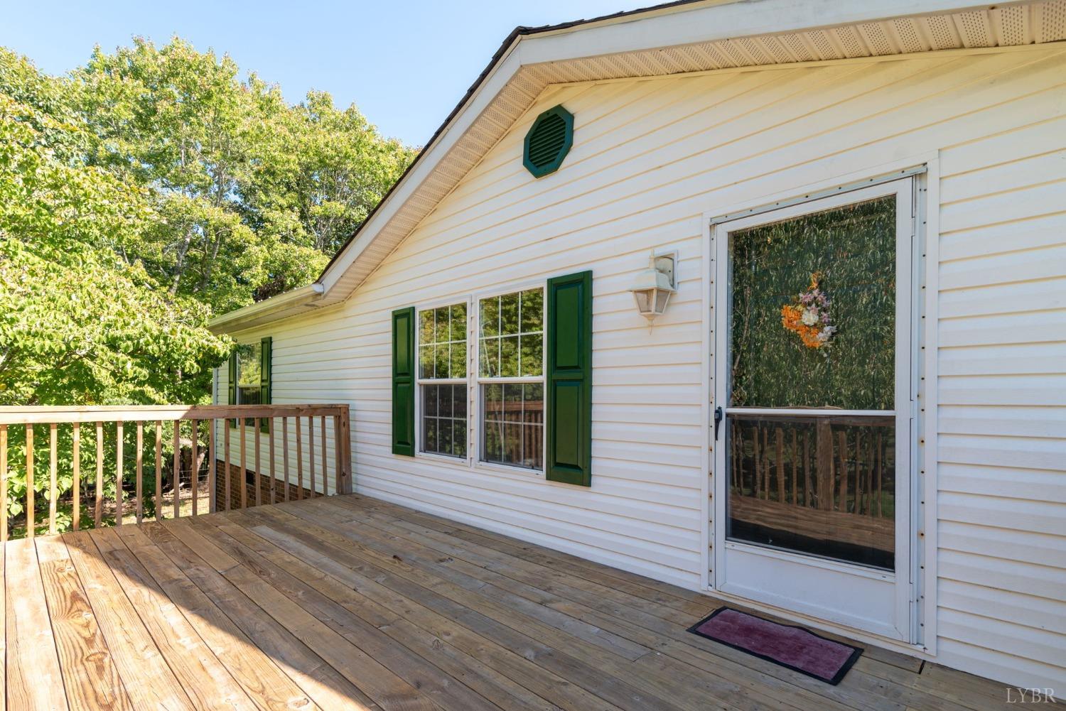 349 Theta Mill Road Gladys, VA 24554 - Photo 3 of 48 a view of a wooden deck and a yard
