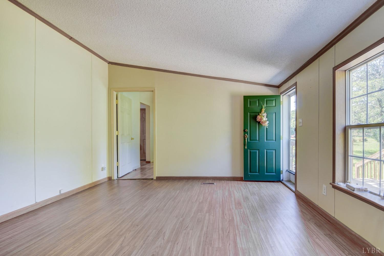 349 Theta Mill Road Gladys, VA 24554 - Photo 4 of 48 an empty room with wooden floor and windows